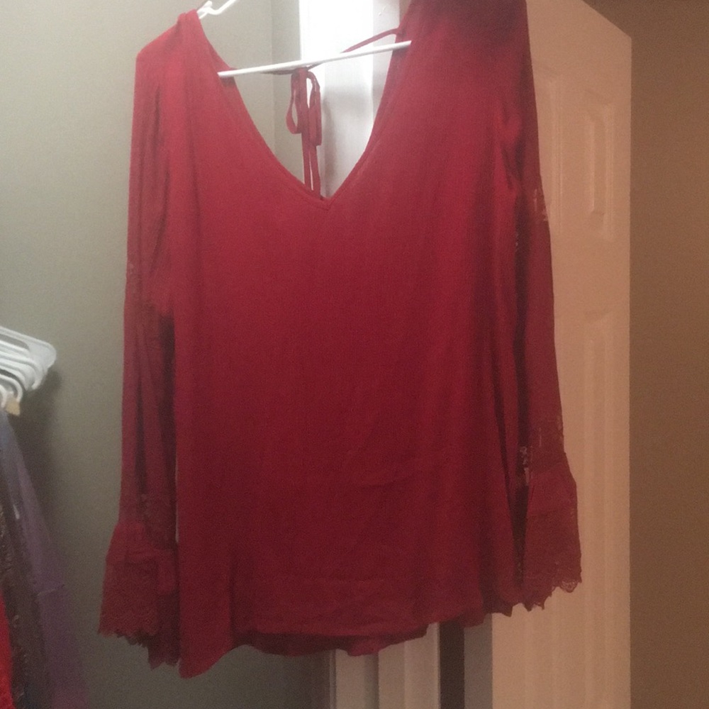 Deep red bell sleeved, detailed lace top